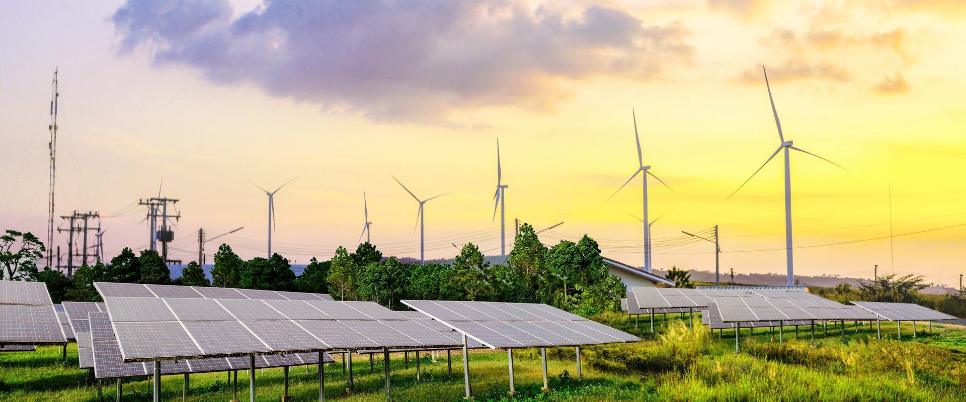 Windkraftanlage hinter Solarpanels